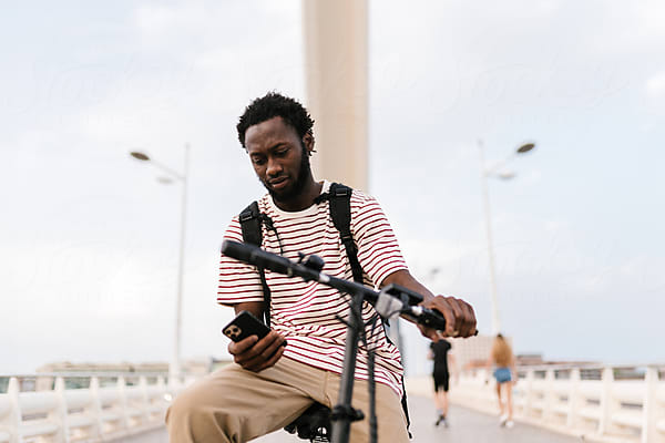Premium Photo  Elegant black man in suit cycling in city sleek bike urban  sophistication bustling streets AI generative