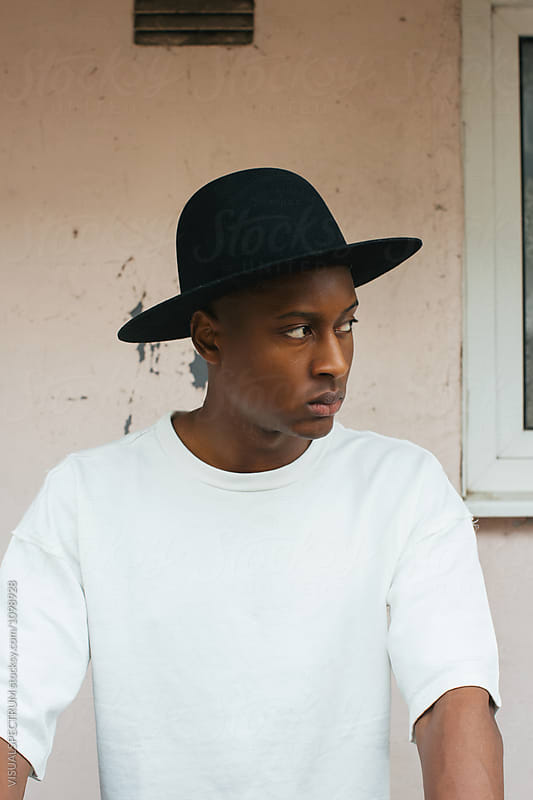 Cool Young Fashionable Black Man With Black Hat Looking Away