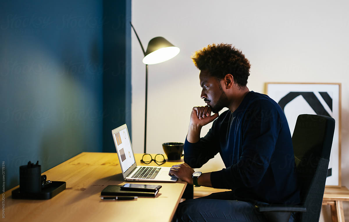Black freelancer thinking over project in workplace