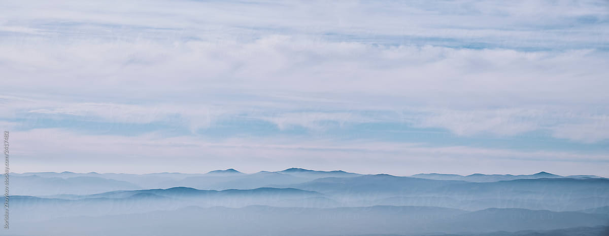 Panoramic view of covered with fog mountains