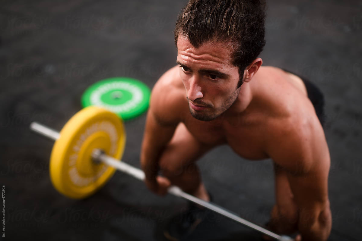 Shirtless athlete during weightlifting workout