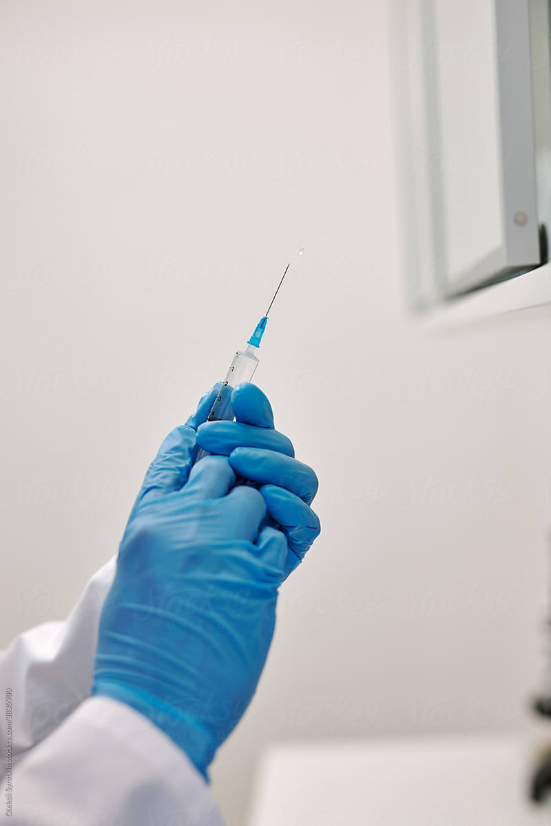 Physician holding syringe with flu vaccine