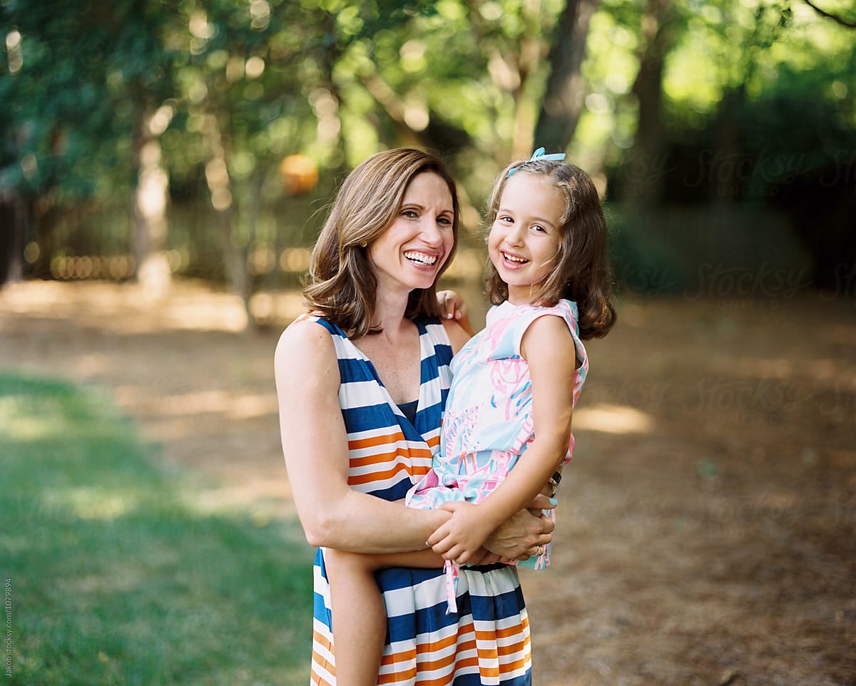 Mother Holding A Beautiful And Playful Daughter By Stocksy Contributor Jakob Lagerstedt