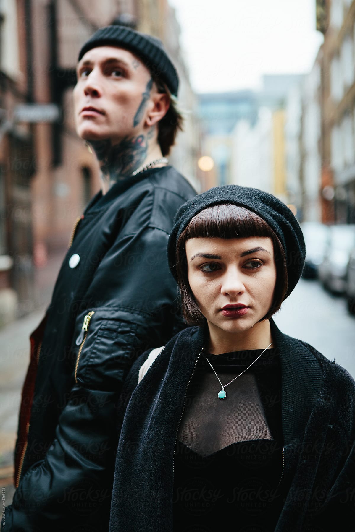 Attractive punk couple looking in opposite directions