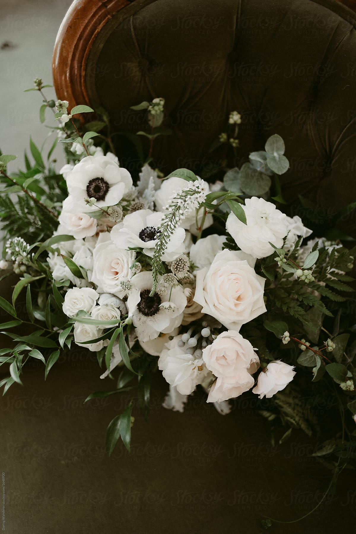 Simple white and green wedding bouquet with vines and white flowers