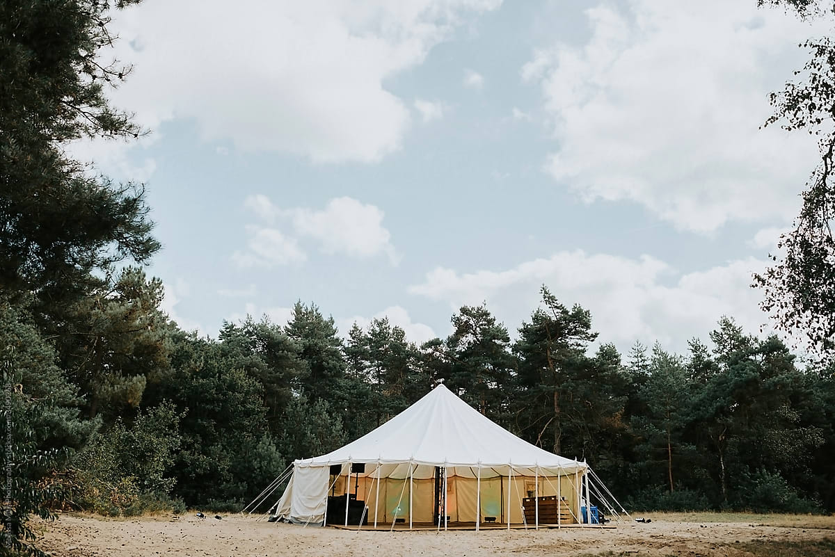 White round tent in the middle of a forest