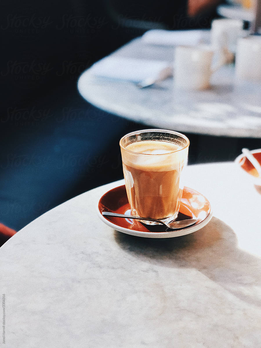 Almond latte on a marble table in a cafe in London, England.