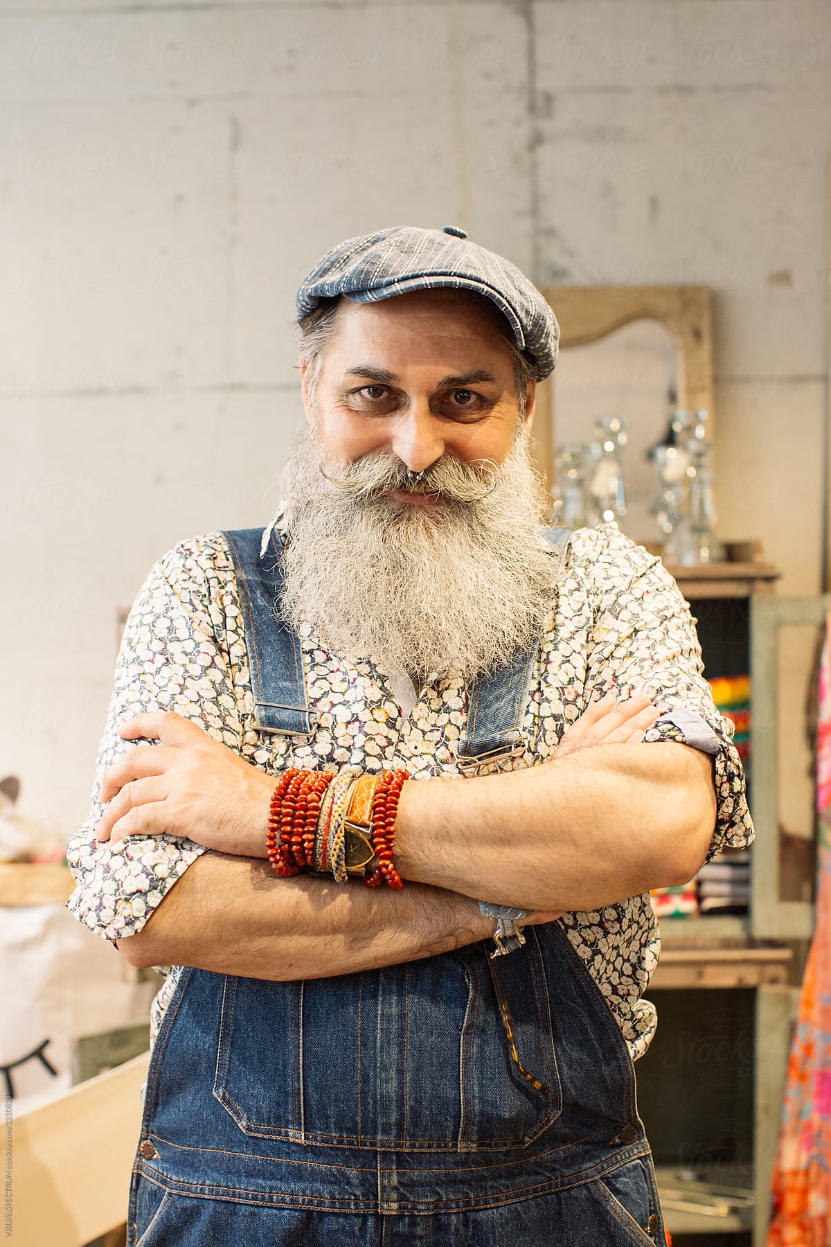 Indoor Portrait of Older Male Hipster Posing With Arms Crossed
