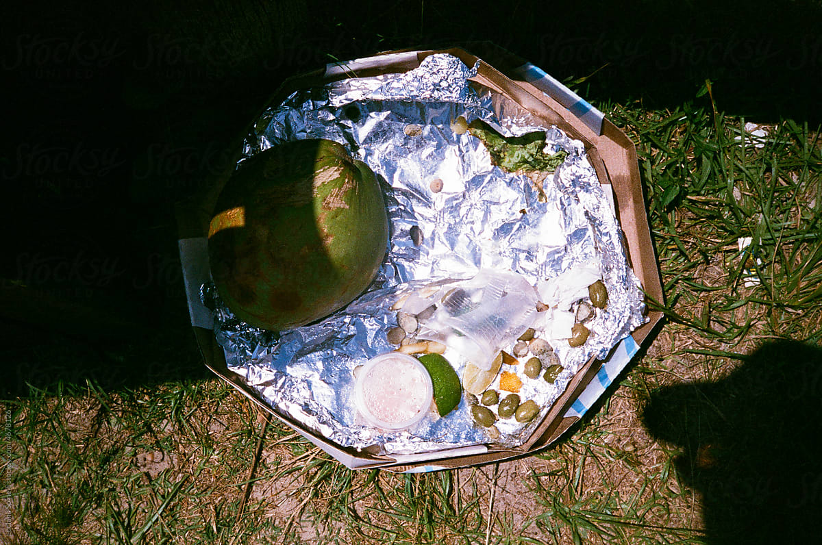 aluminum pizza packaging with trash inside and a coconut olives lime