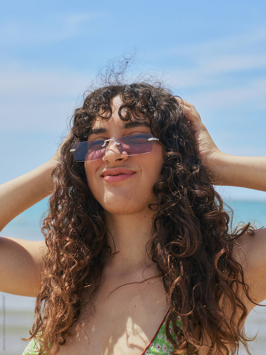 Coastal Fun and Confidence: Curly-haired Woman Portrait
