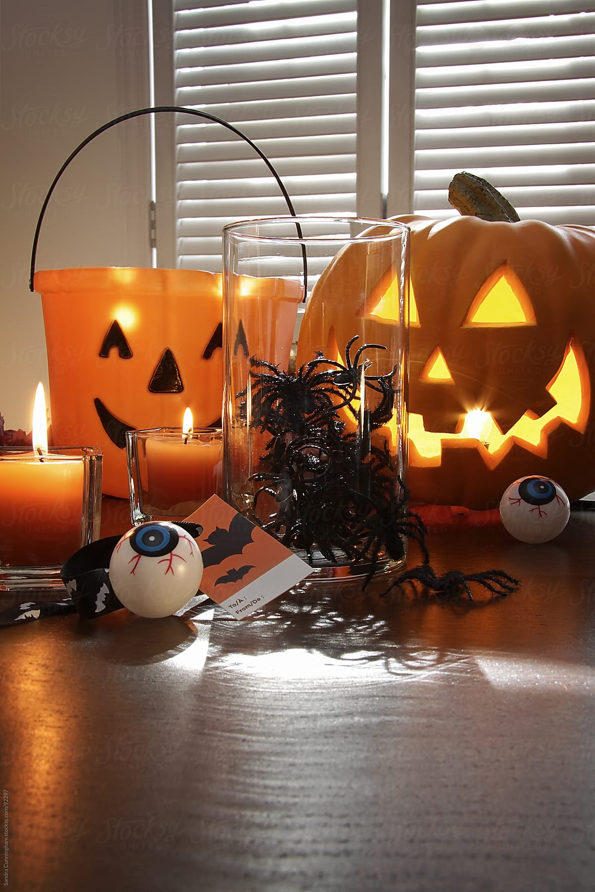 Pumpkin, candles and spiders in a jar for Halloween