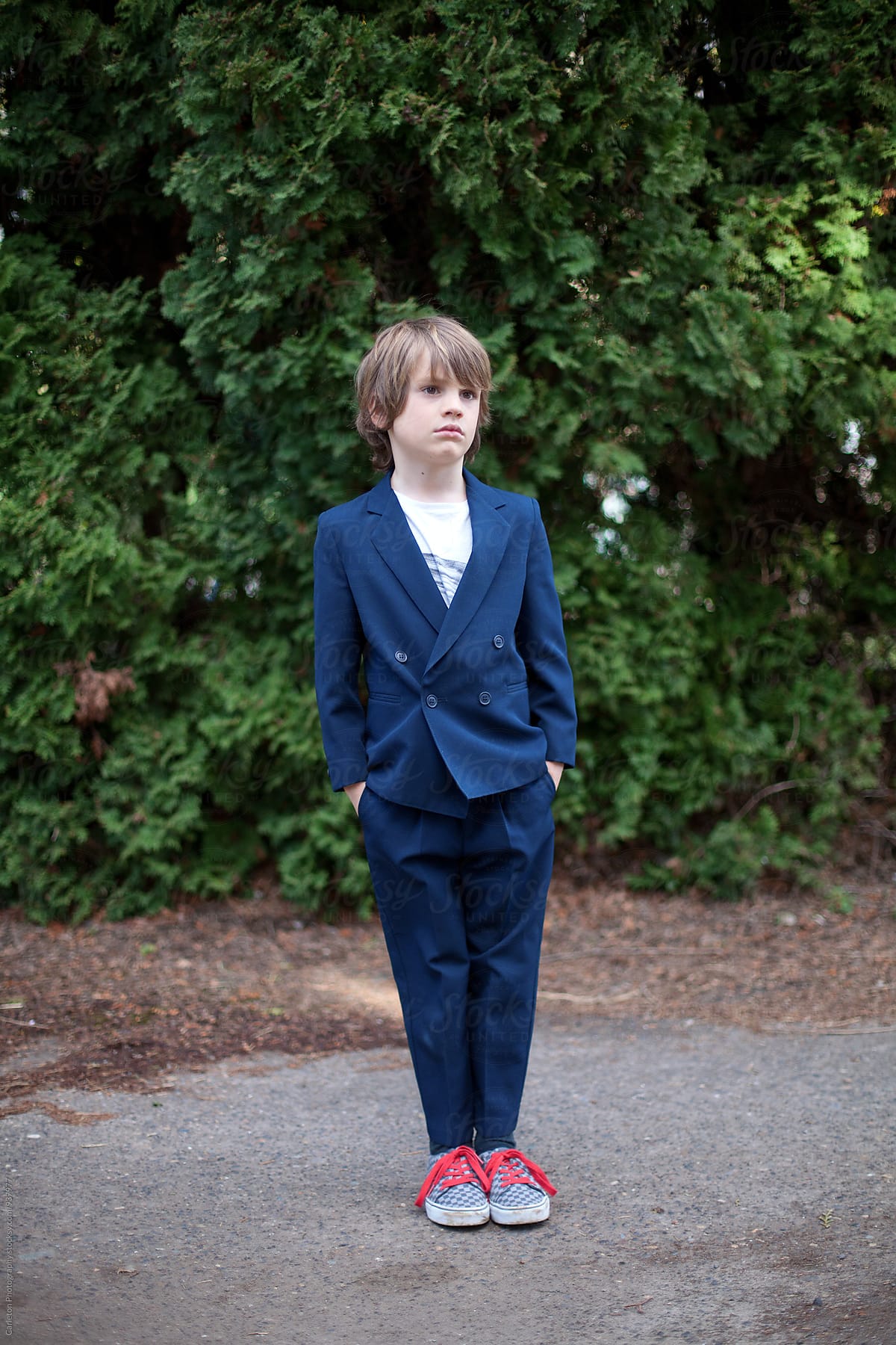 Boy in blue suit with t-shirt and skater shoes