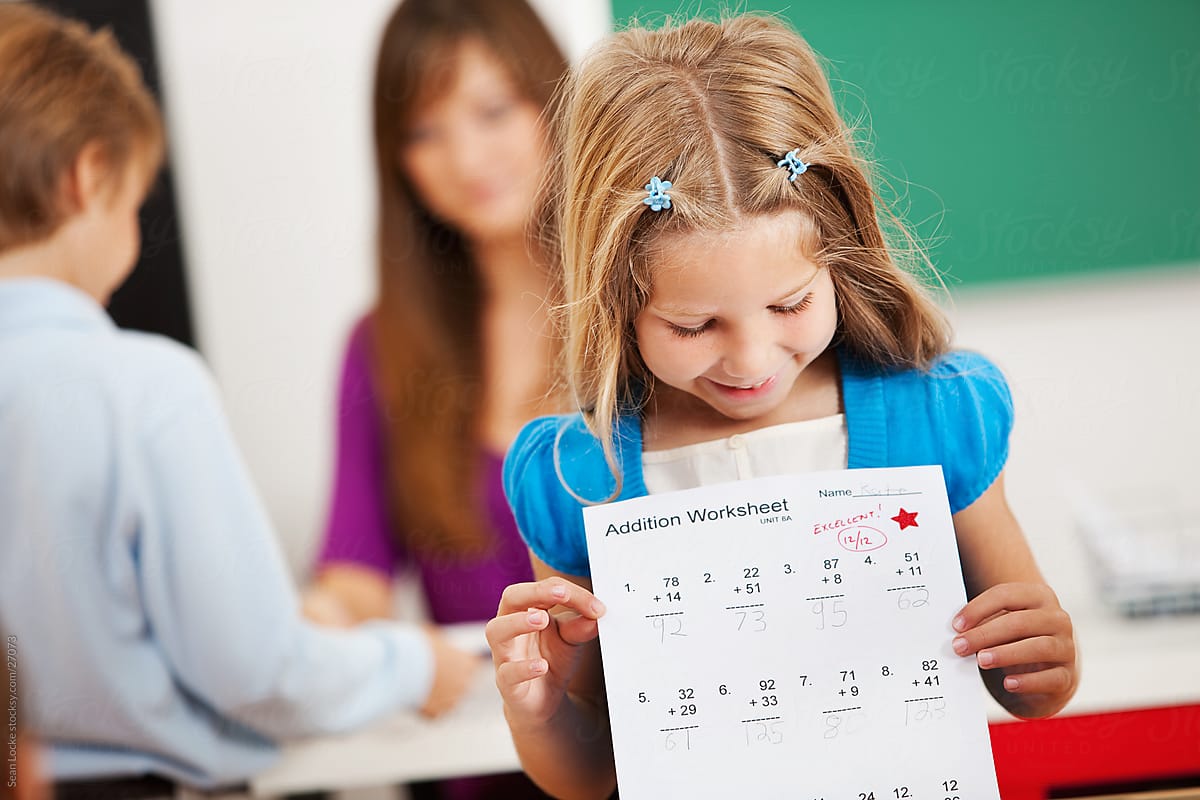 Classroom: Girl Proud of Great Grade on Paper