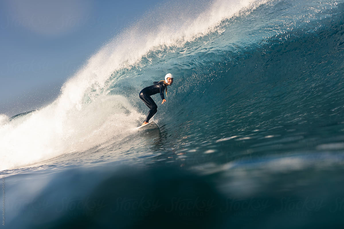 Girl surfing big wave.