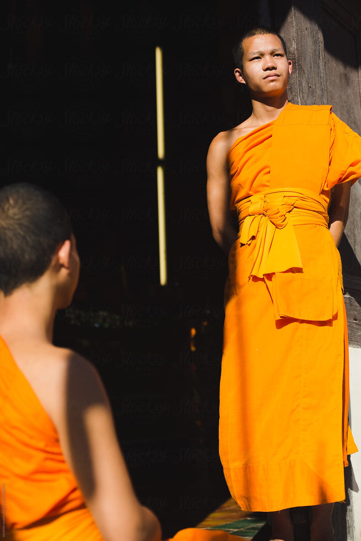 Young Buddhist monks at the temple entrance