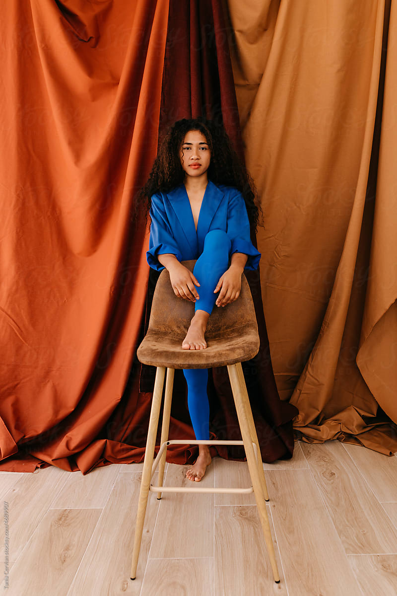 Female model holding leg on chair