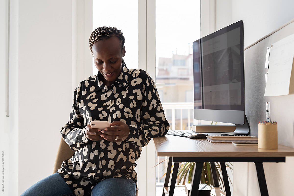 Content black woman watching video on smartphone