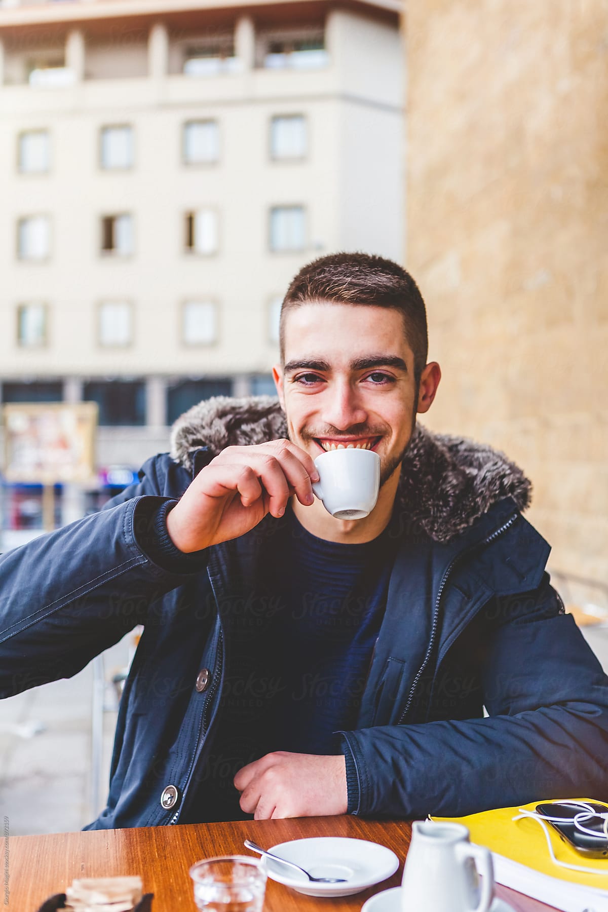 Young Man Having an Italian Espresso during the Cold Season
