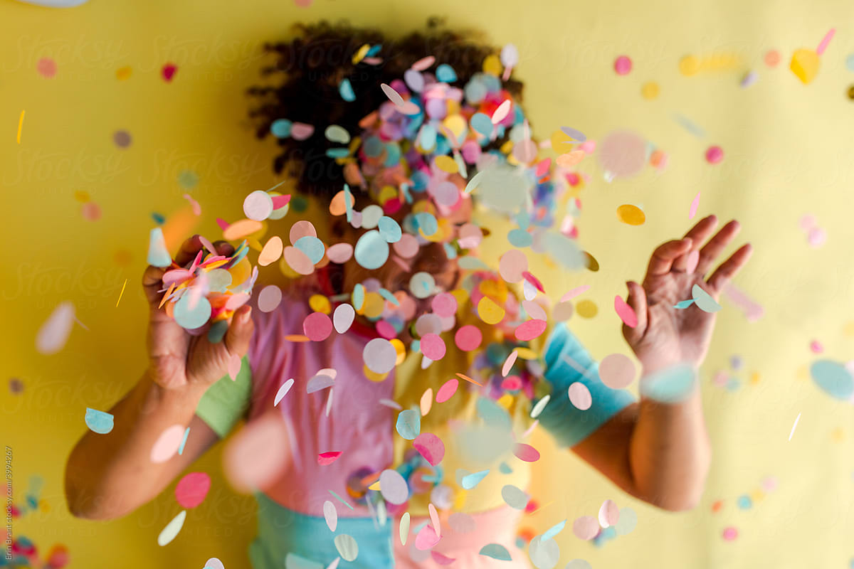 Woman obscured by falling confetti
