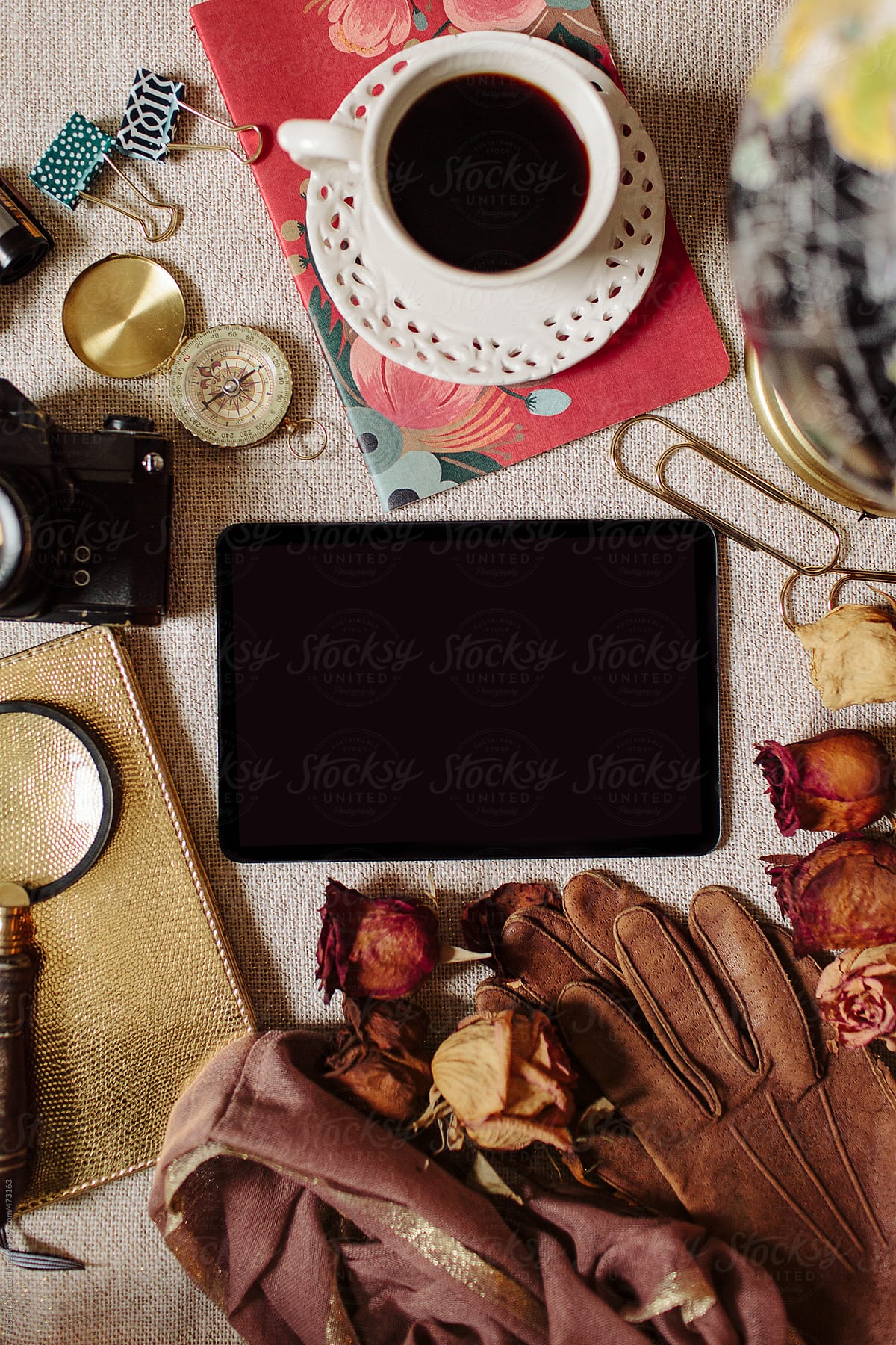 A smart tablet surround by traveling accessories