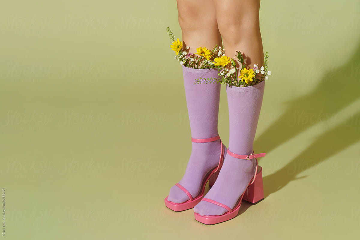 Girl showing legs and wearing flowers in the socks
