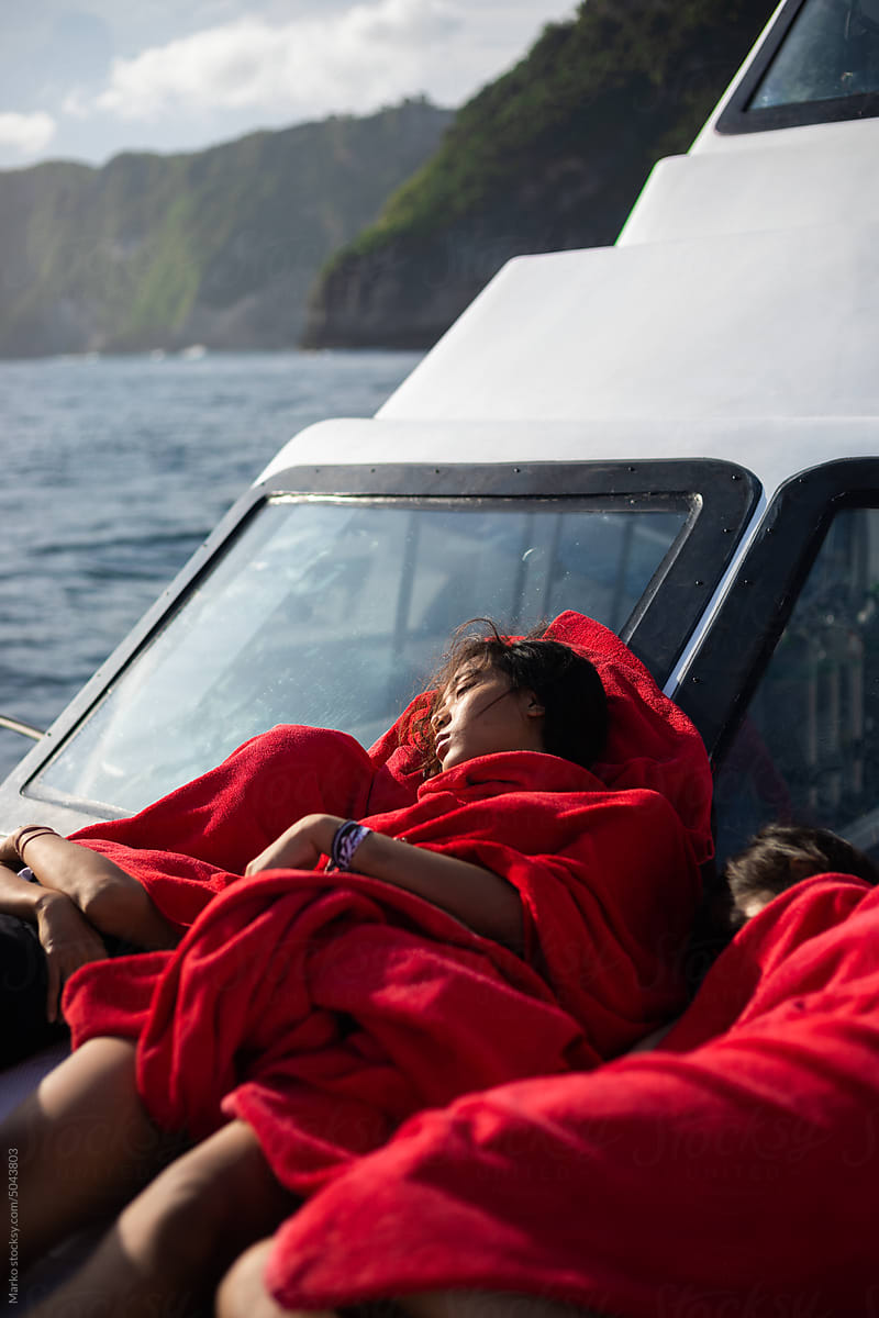 Girls sleeping at boat sunbathing