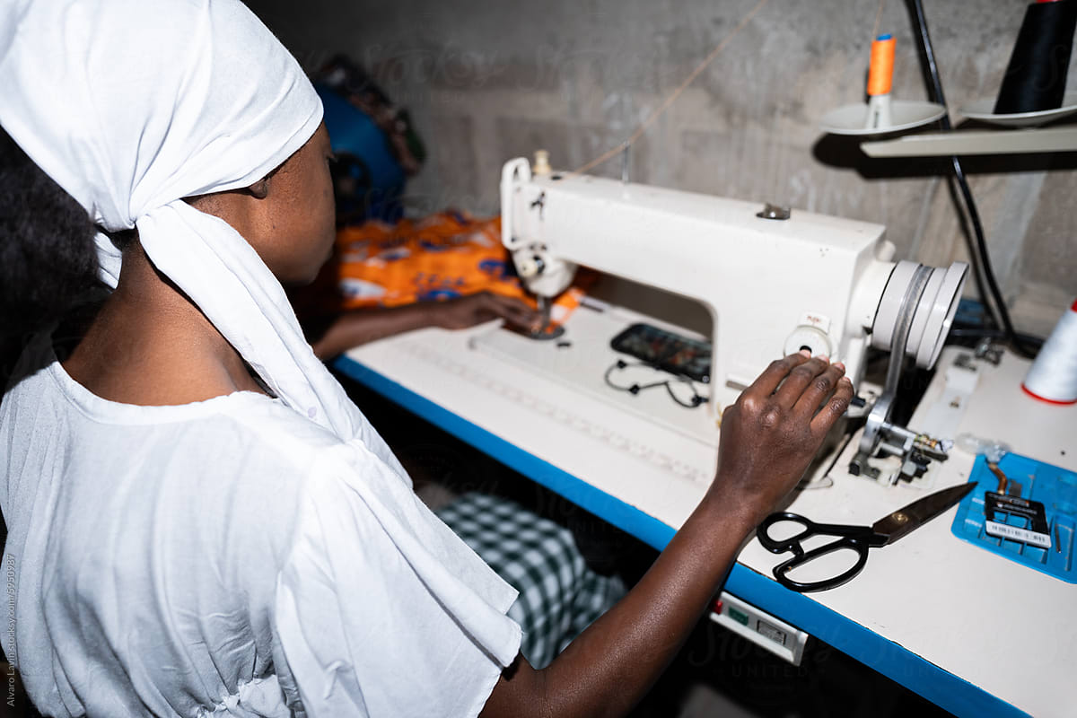 Senegalese Woman Sewing Her Own Dress at Home With Traditional Sewing