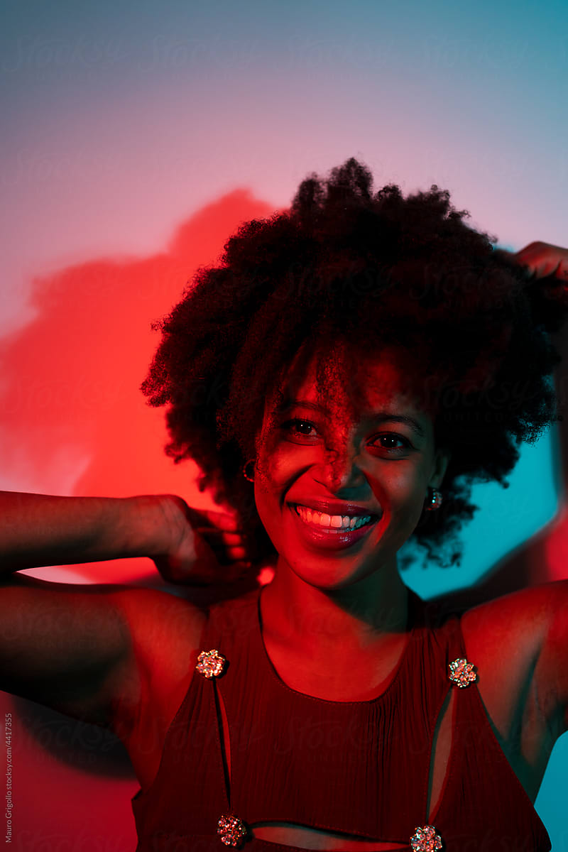 Smiling woman in a red and blue light