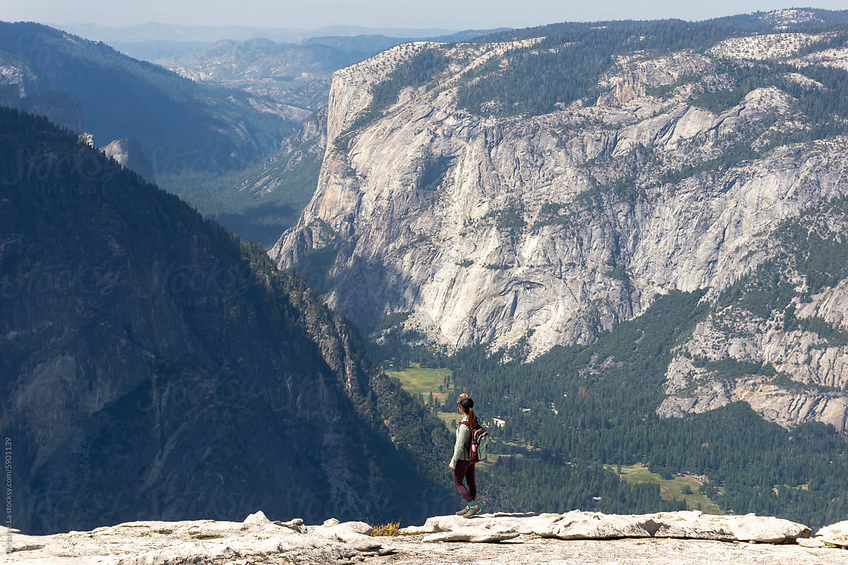 Tourist standing on top of Half Dome, Yosemite