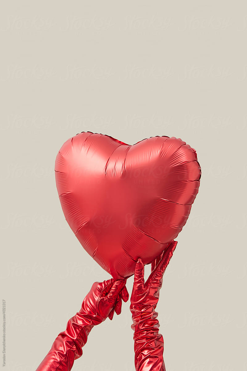 Close up of heart shaped balloon in female hands