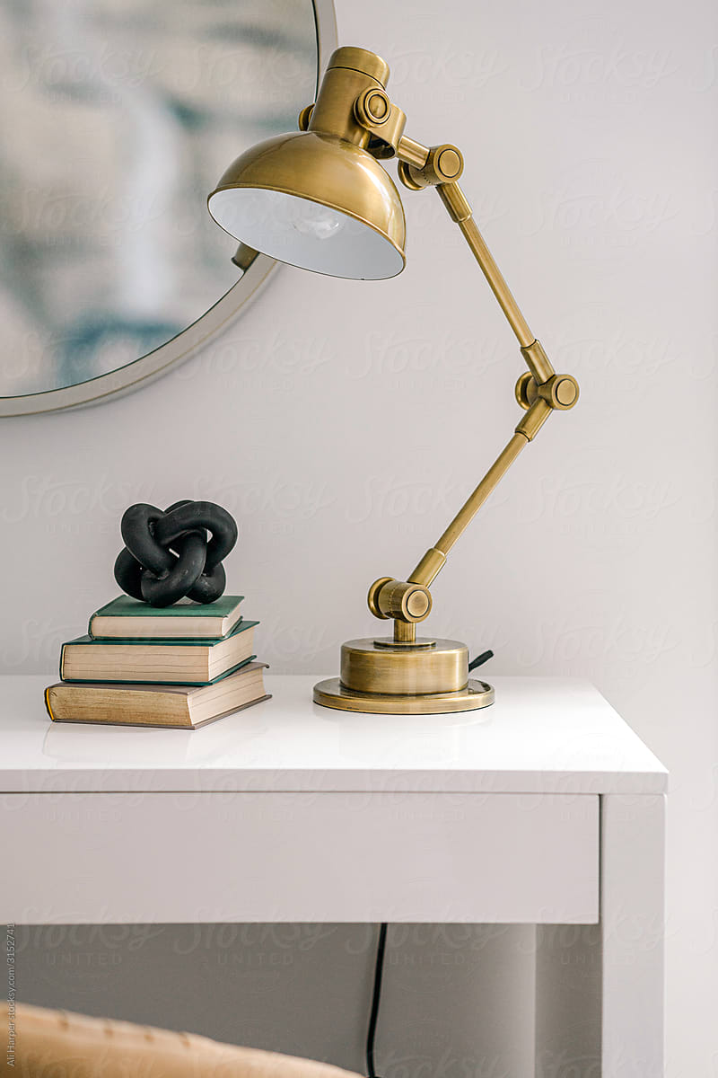Home office work space with gold lamp