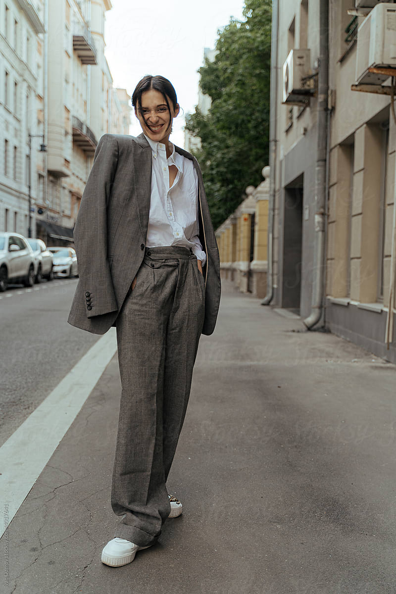 non-binary person in a man\'s suit in the city