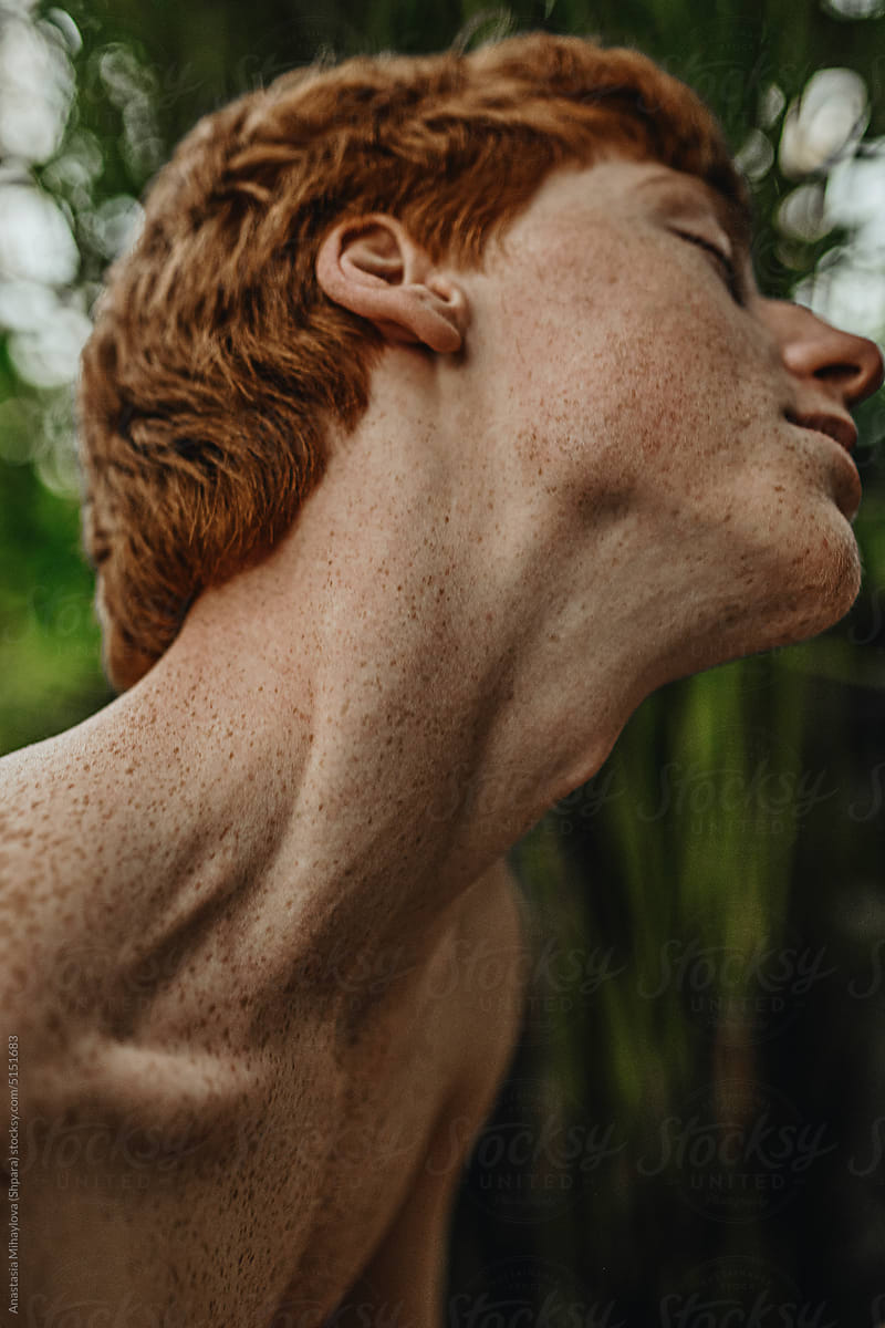 Close-up Half-Face Portrait Freckled Ginger Man\'s Neck in the Jungle
