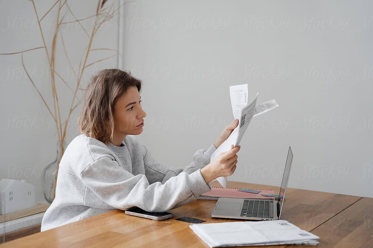 Woman paying bills from home on laptop