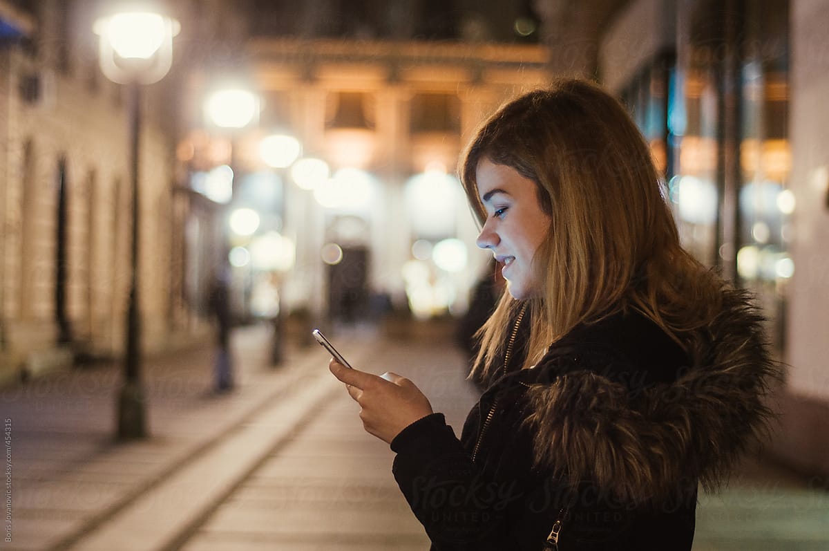 Woman usinng a smartphone on the street