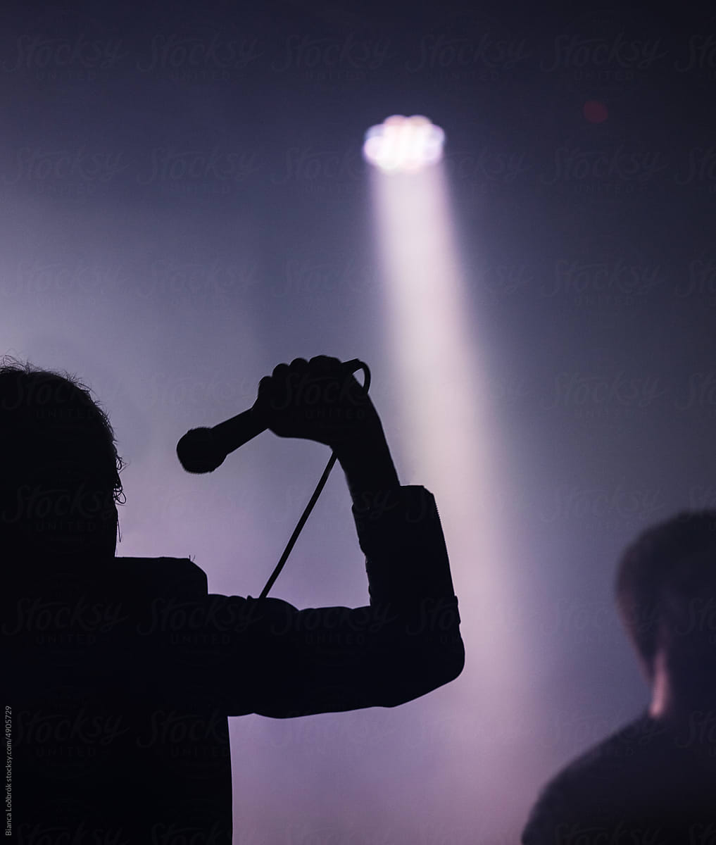 Silhouette of a hard rock band singer