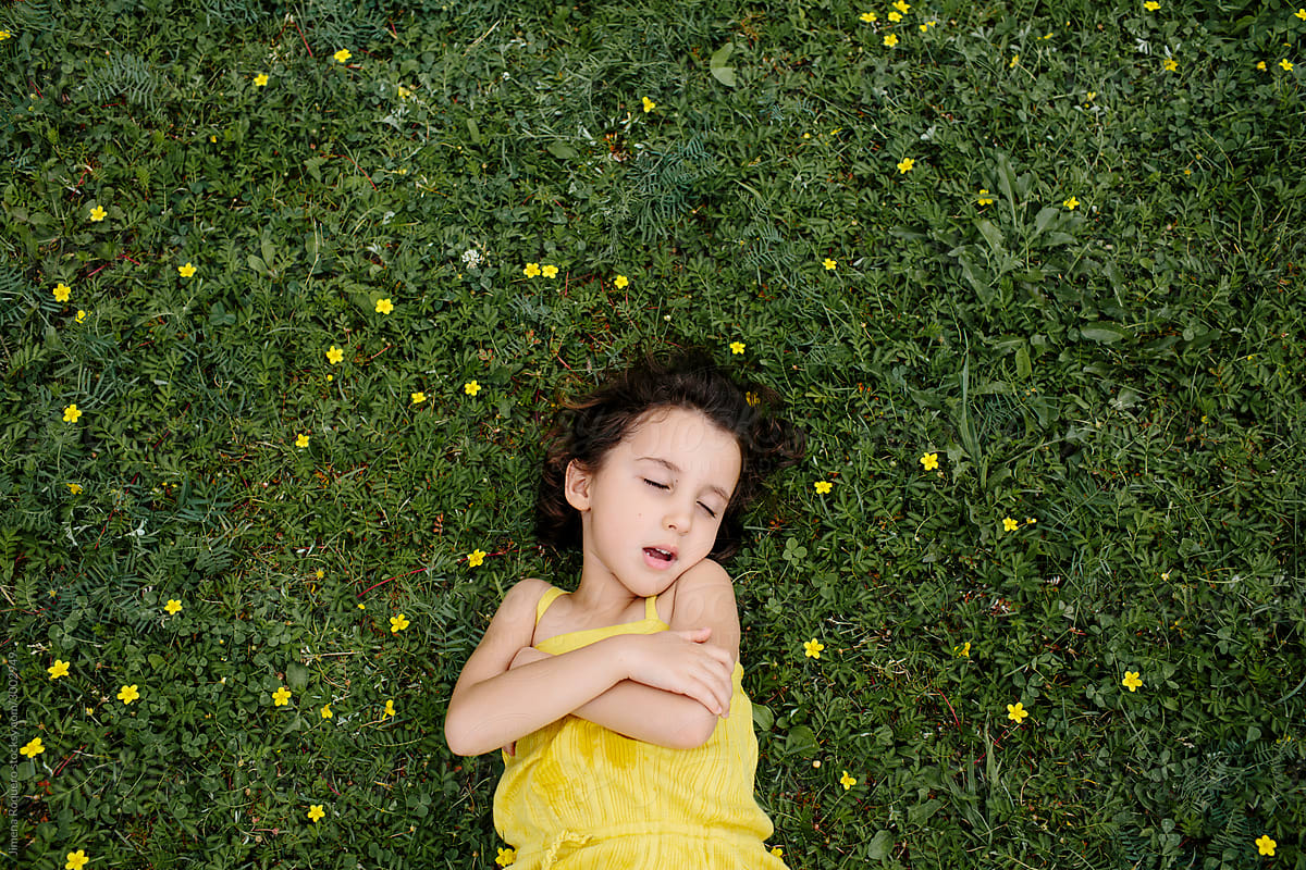 Kid lying on grass
