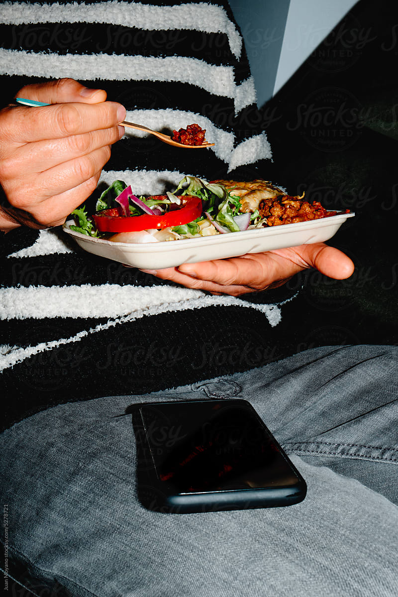 man eating some salad and moussaka