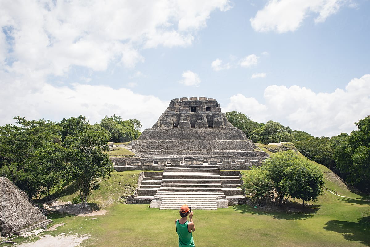 Man Taking Photo of Mayan Temple with Phone