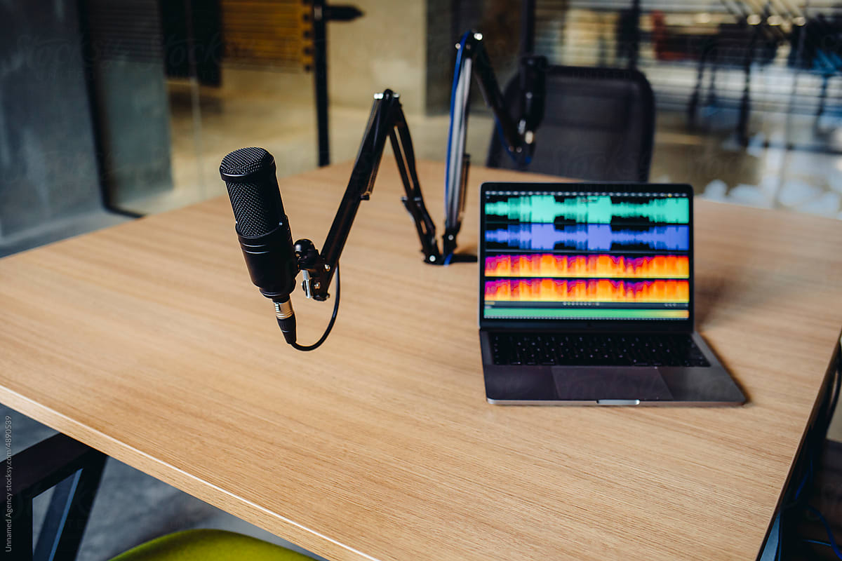 Podcast microphone and a laptop on a desk