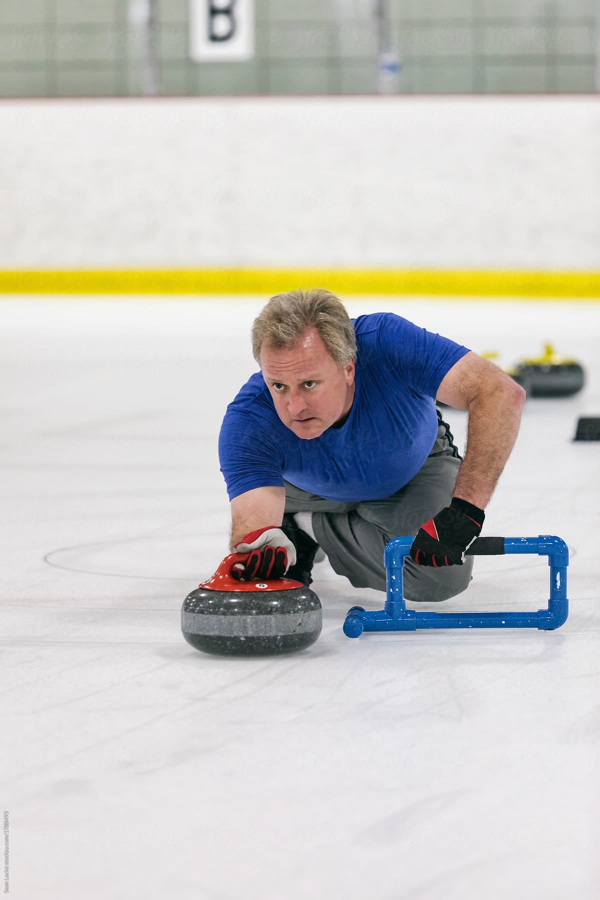 Curling: Man Throwing Stone During Game Play