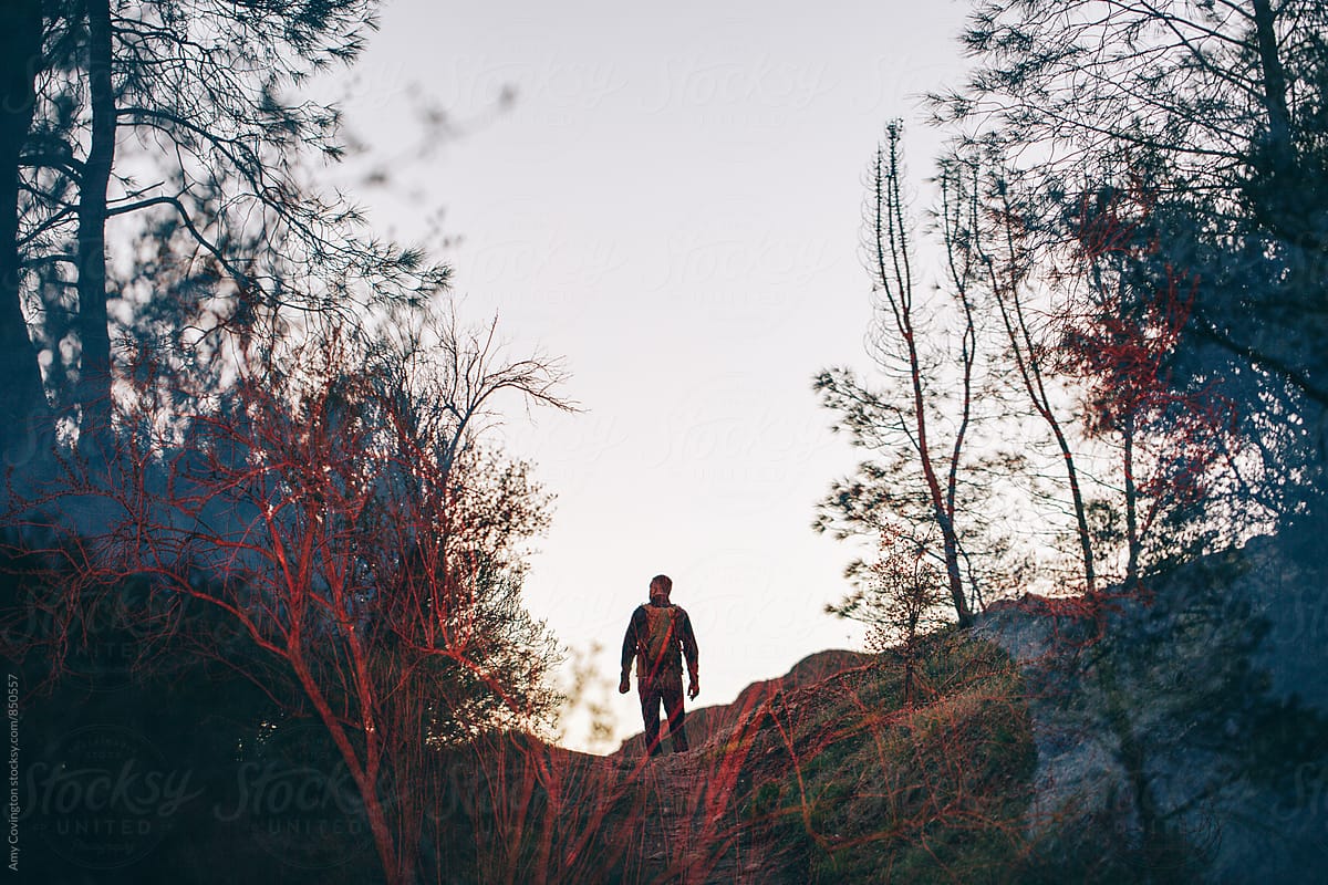 Double exposure of a man hiking from behind