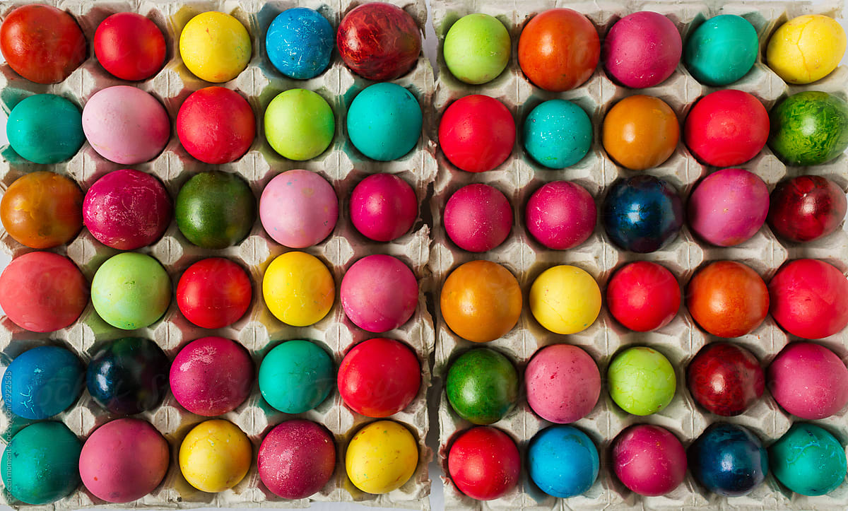 Multicolored Easter eggs in the package on the white background. Copyspace. Still life photo of lots of colorful easter eggs.Background with easter eggs.  Easter photo concept
