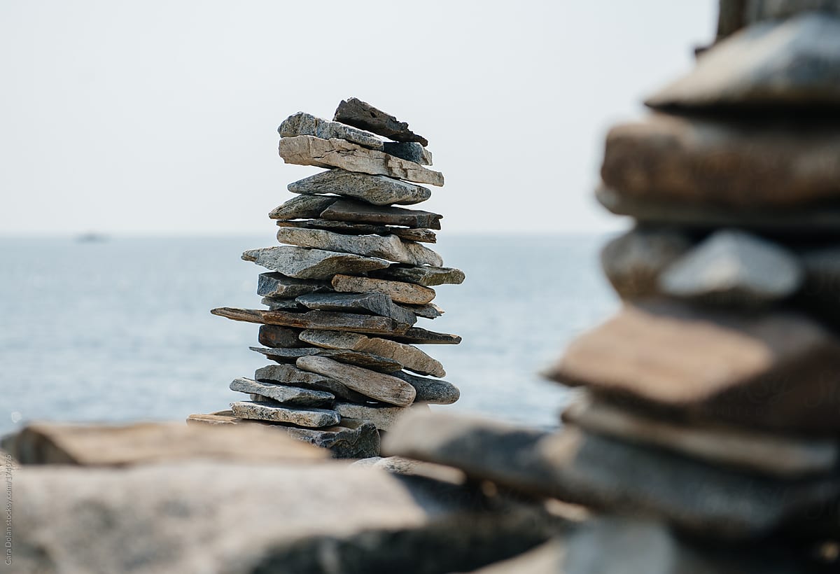 Stacks of flat rocks stand overlooking the ocean