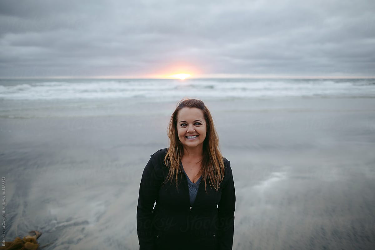 Smiling Middle Aged Man On The Beach At Sunset by Stocksy Contributor Rob  And Julia Campbell - Stocksy