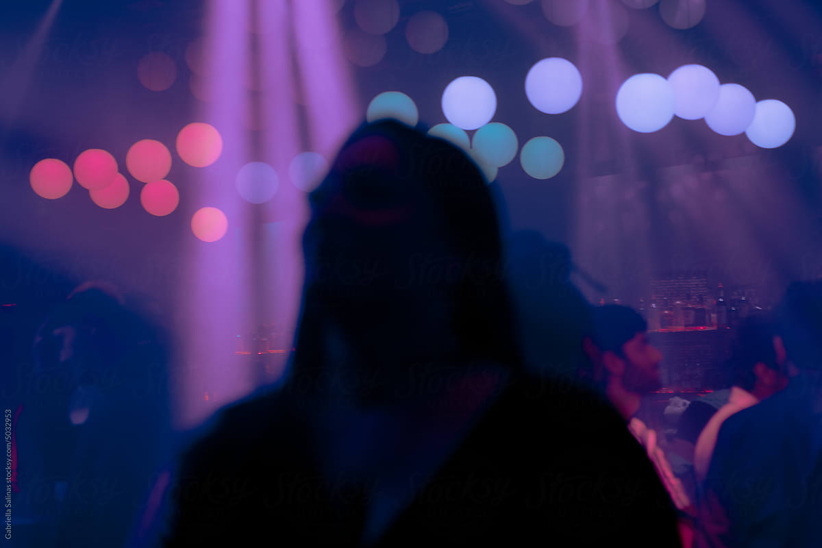 Young woman looking up in a nightclub