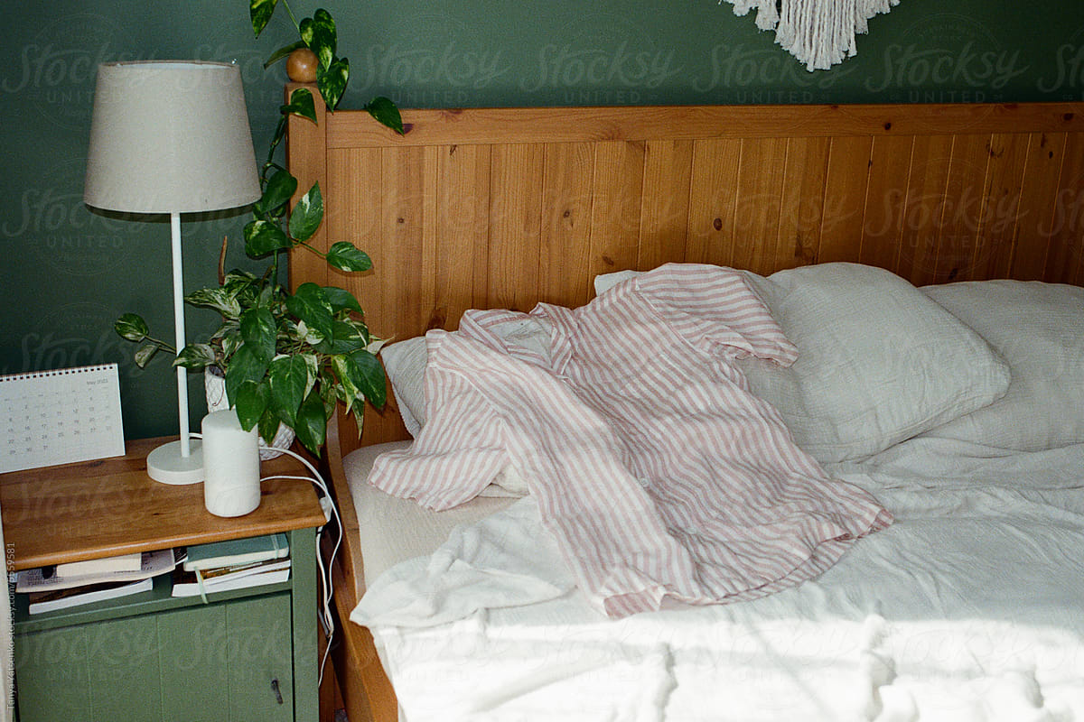 A Part View Of A Bedroom with Green Wall