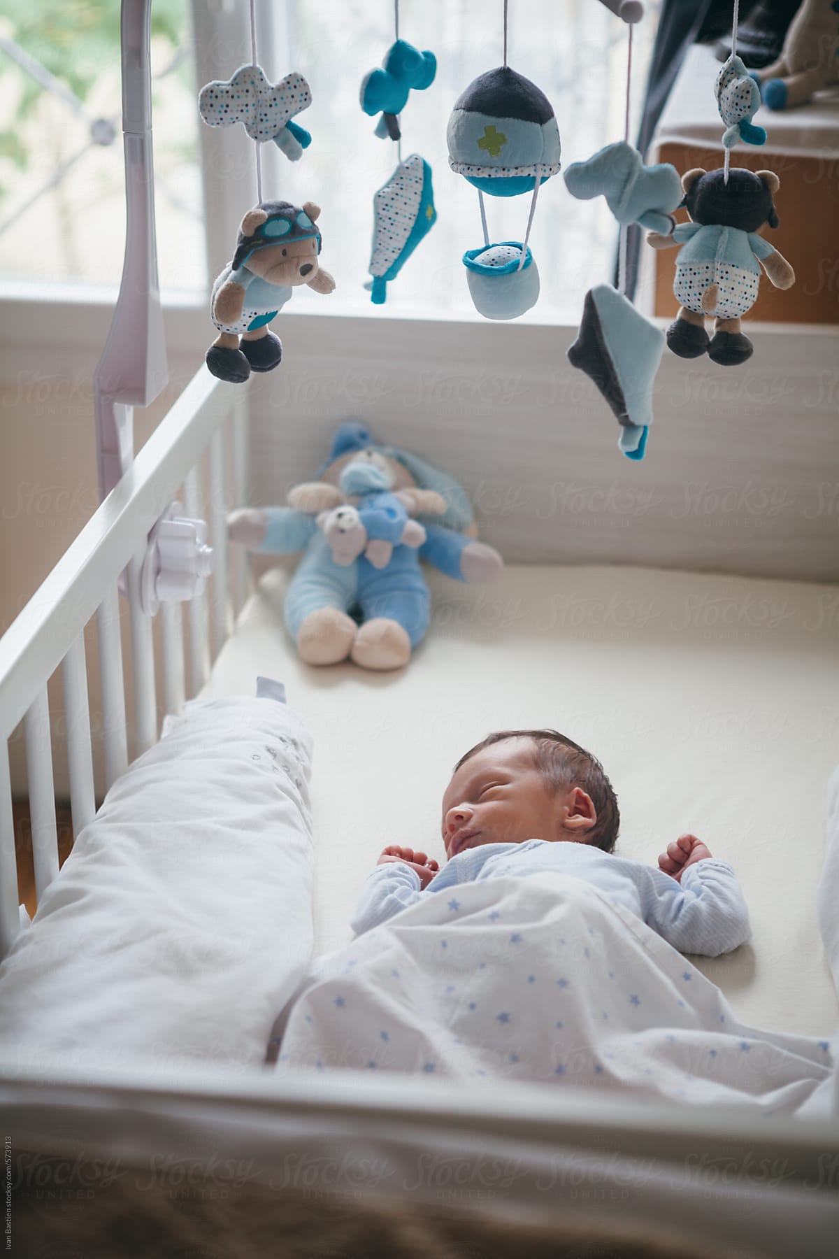 Newborn boy sleeping in a crib