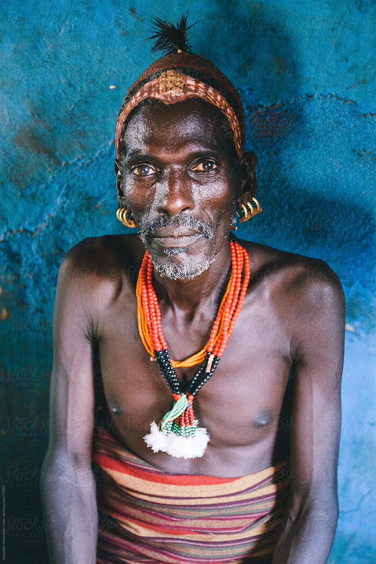 Hamer tribe senior man portrait with traditional clothes on a local bar. Omo Valley, Ethiopia
