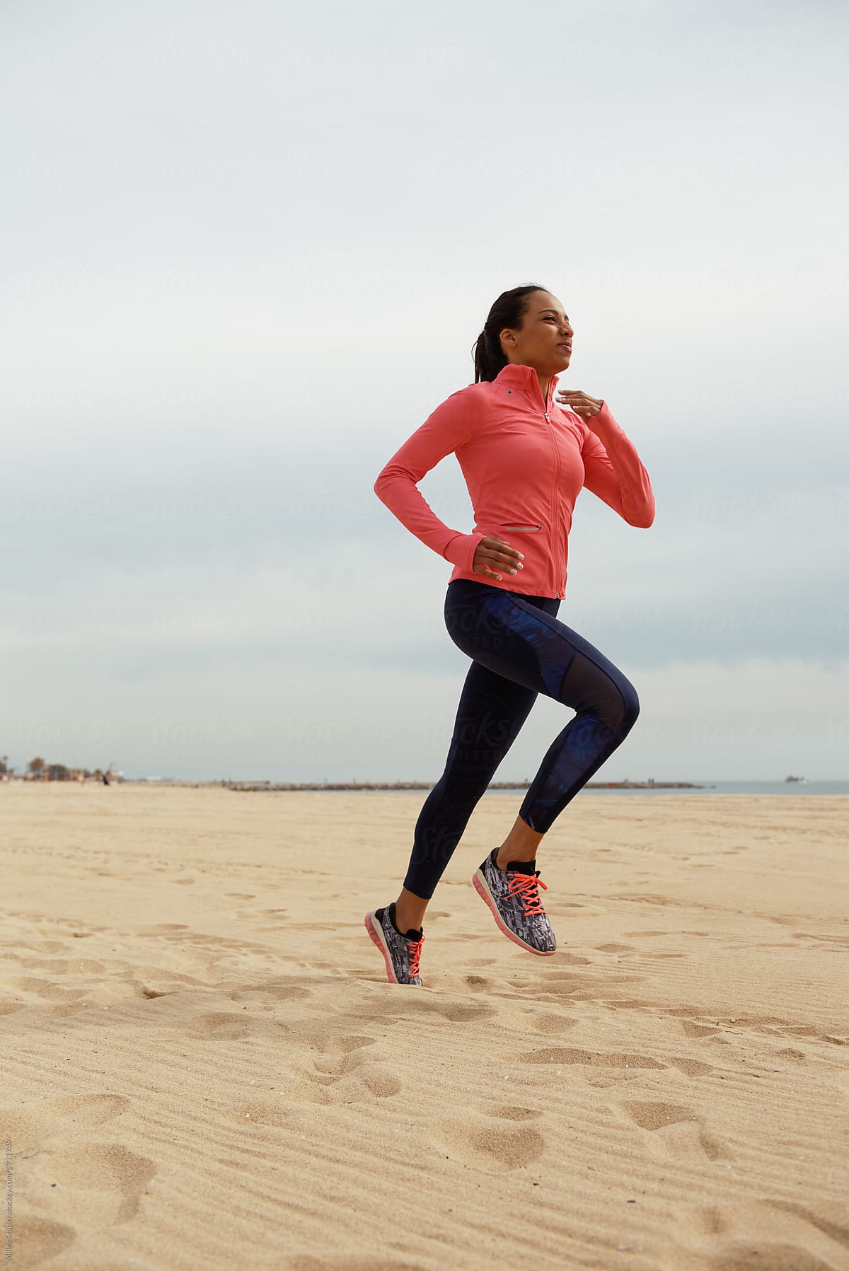 Sportive Black Woman Running On Sand by Stocksy Contributor Milles  Studio - Stocksy
